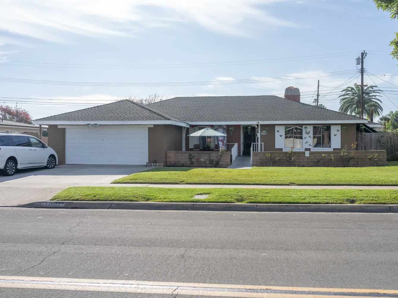 Front exterior view of single-story residential care home with maintained lawn and accessible entry