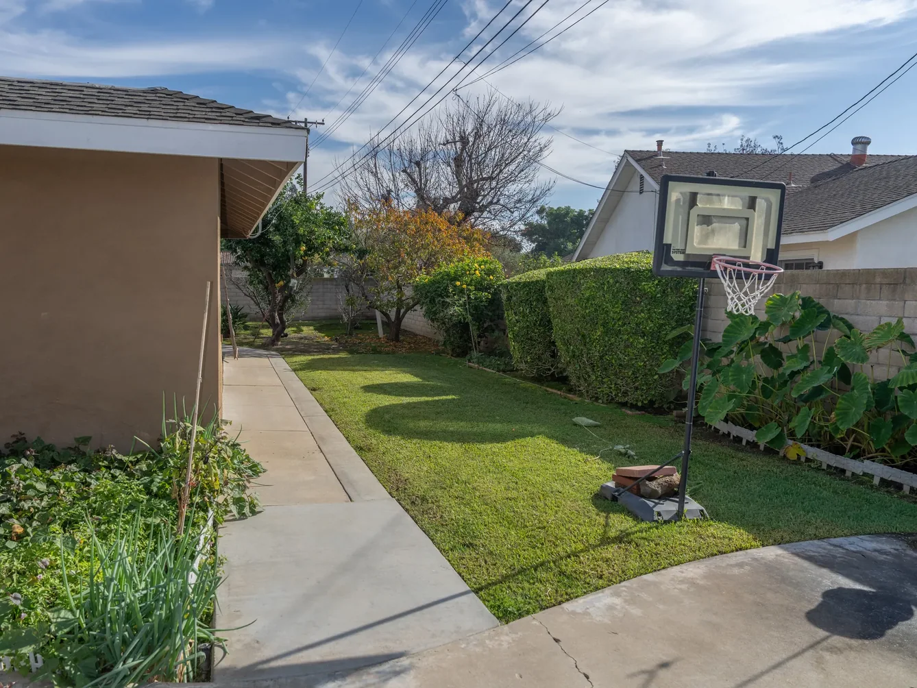 Spacious backyard with green lawn and recreational area at residential care facility